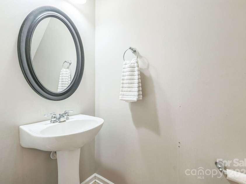 8009 Whitehawk Hill Road, Waxhaw, NC 28173.  MLS# CAR4232872, YatesRealty ID 16475. Convenient main-level half bath with pedestal sink.