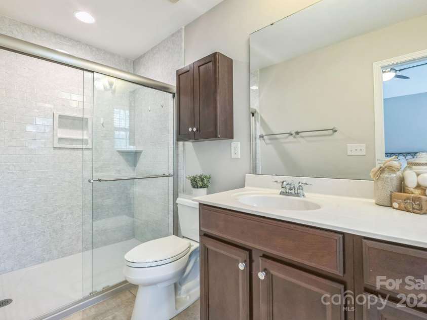 8009 Whitehawk Hill Road, Waxhaw, NC 28173.  MLS# CAR4232872, YatesRealty ID 16475. Elegant primary bath featuring a modern, updated low-entry shower for easy access.