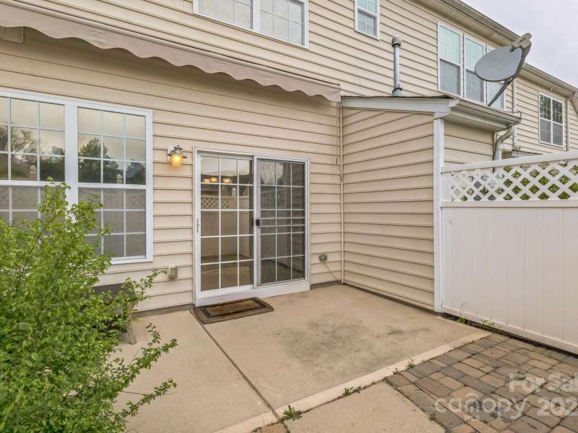 8009 Whitehawk Hill Road, Waxhaw, NC 28173.  MLS# CAR4232872, YatesRealty ID 16475. Sunny outdoor retreat with a fenced patio, perfect for enjoying the warmth when the awning is retracted.