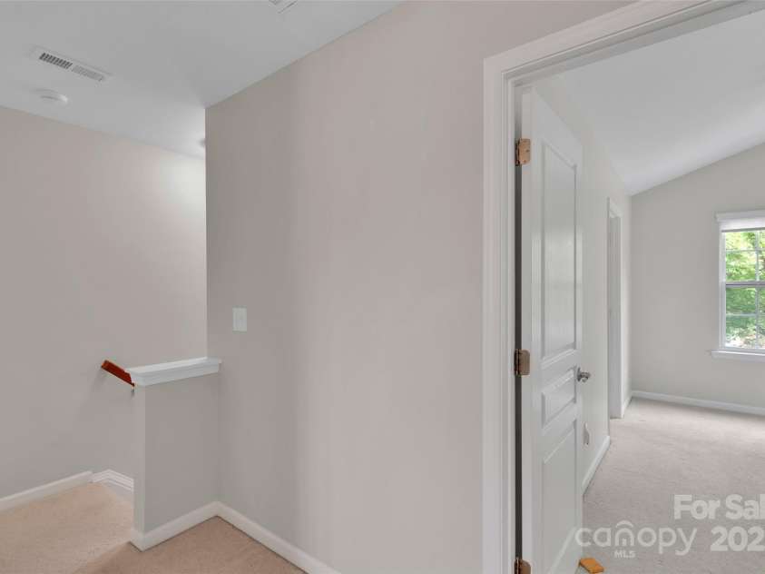 8009 Whitehawk Hill Road, Waxhaw, NC 28173.  MLS# CAR4232872, YatesRealty ID 16475. Upstairs hallway view to stairs & primary suite.