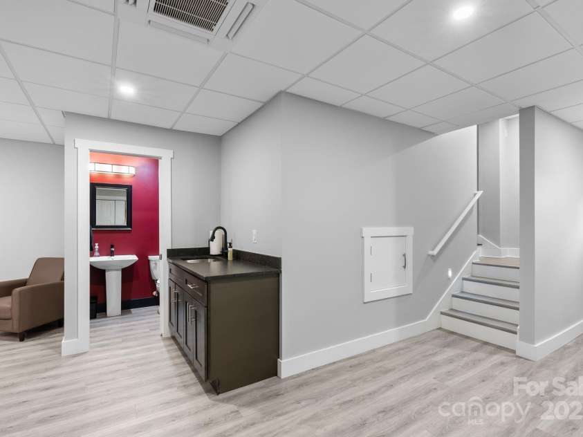 353 Olivet Lane, Fletcher, NC 28732.  MLS# CAR4226055, YatesRealty ID 16483. Basement hallway showing half bath