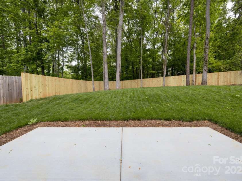 15 Myrtle Lee Cove, Arden, NC 28704.  MLS# CAR4254798, YatesRealty ID 16491. Back patio and yard