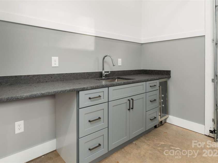 106 Isle Of Pines Road, Mooresville, NC 28117.  MLS# CAR4307196, YatesRealty ID 165. Convenient shop wet bar with full sink and beverage refrigerator - interior of lot 1 home