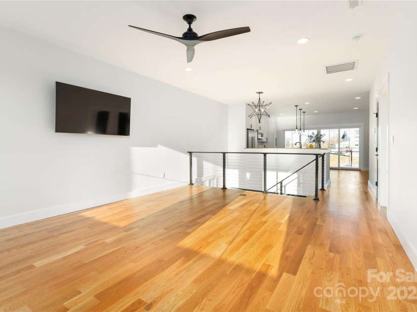 106 Isle Of Pines Road, Mooresville, NC 28117.  MLS# CAR4307196, YatesRealty ID 165. Living space with site finished hardwoods throughout second level - interior of lot 1 home