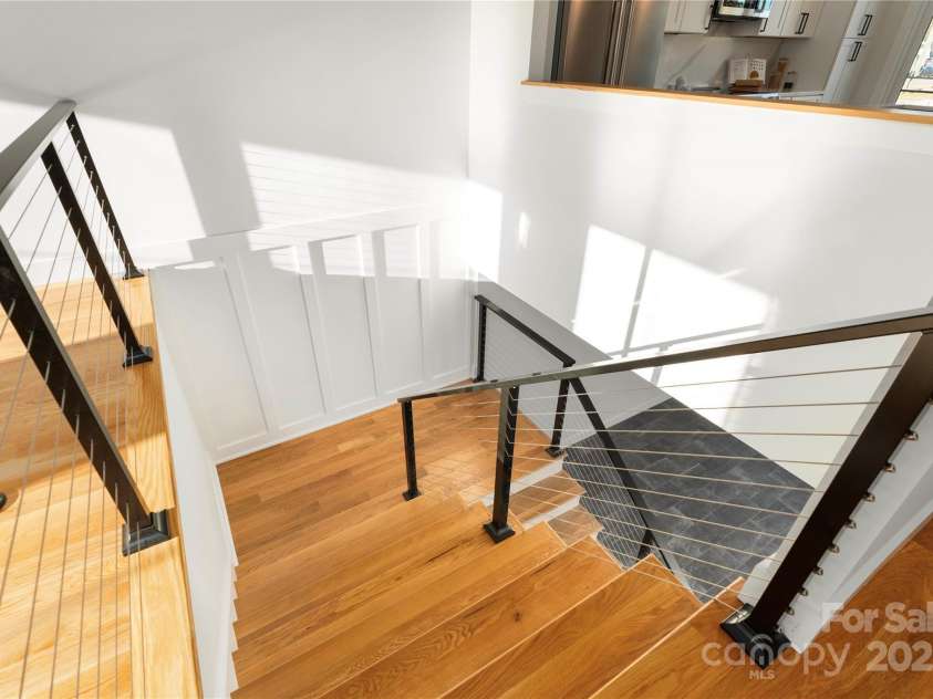 106 Isle Of Pines Road, Mooresville, NC 28117.  MLS# CAR4307196, YatesRealty ID 165. Open staircase.  Large windows and doors throughout flood the home with natural lighting.  Interior of lot 1 home.