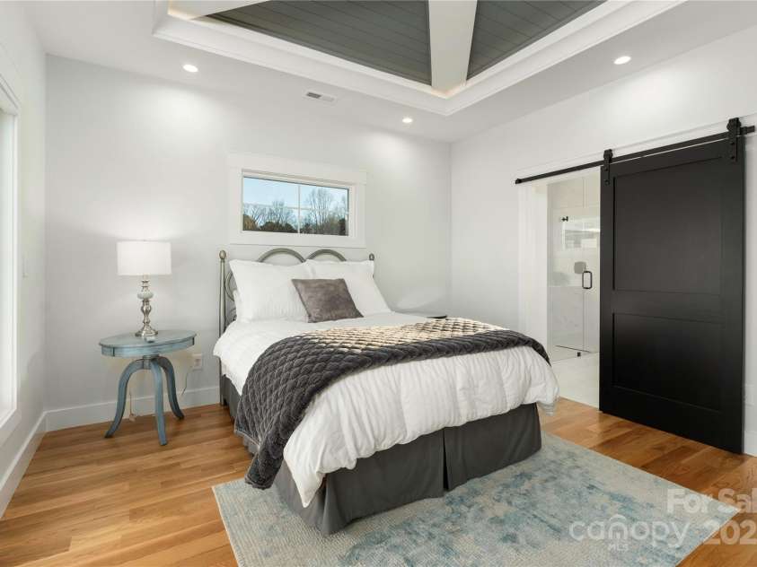 106 Isle Of Pines Road, Mooresville, NC 28117.  MLS# CAR4307196, YatesRealty ID 165. Primary bedroom with custom barn door to primary bath - interior lot 1 home