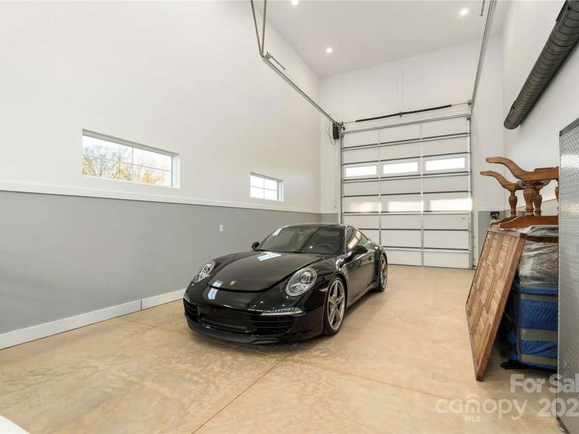 106 Isle Of Pines Road, Mooresville, NC 28117.  MLS# CAR4307196, YatesRealty ID 165. Space for RV with doors at both ends of garage - interior of lot 1 home