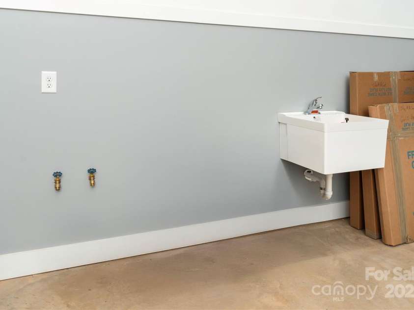 106 Isle Of Pines Road, Mooresville, NC 28117.  MLS# CAR4307196, YatesRealty ID 165. Utility sink and hot/cold connections in conditioned garage space - interior of lot 1 home