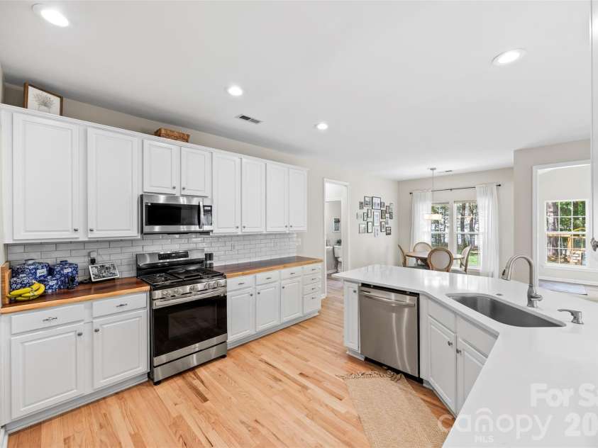 1229 Periwinkle Drive, Waxhaw, NC 28173.  MLS# CAR4373311, YatesRealty ID 16507. Modern kitchen featuring quartz and live edge Acacia