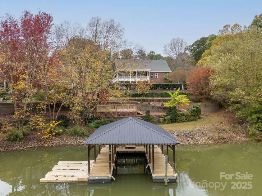 271 Lockhard Circle, Troutman, NC 28166.  MLS# CAR4194496, YatesRealty ID 16508. THE COVERED DEEDED DOCK INCLUDES A BOAT LIFT AND 3 JET SKI DOCKS