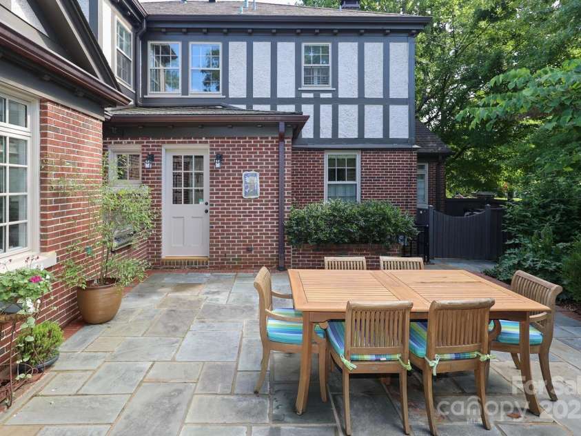 801 Berkeley Avenue, Charlotte, NC 28203.  MLS# CAR4243882, YatesRealty ID 16552. Beautifull stone terrace for dining and entertaining.
