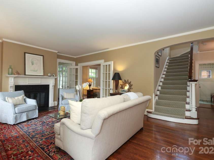801 Berkeley Avenue, Charlotte, NC 28203.  MLS# CAR4243882, YatesRealty ID 16552. Living room with original fireplace, high ceilings and hardwood floors