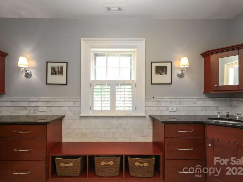801 Berkeley Avenue, Charlotte, NC 28203.  MLS# CAR4243882, YatesRealty ID 16552. Primary bath with dual vanities, custom tile work and walk in shower