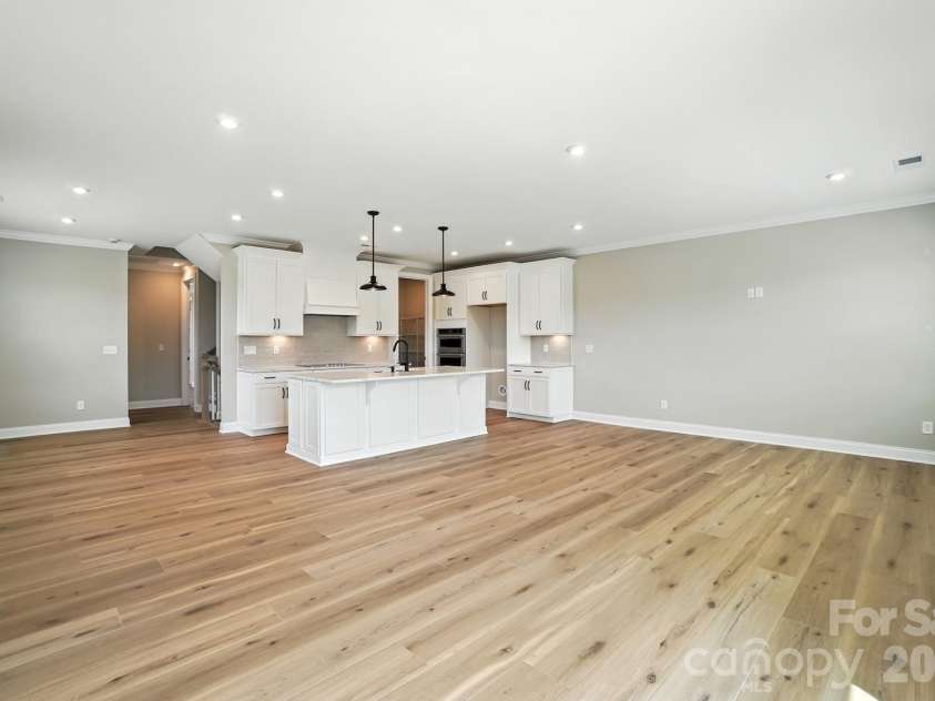 12015 Lavinia Lane, Charlotte, NC 28277.  MLS# CAR4375413, YatesRealty ID 16568. Representation from dining to great room to kitchen