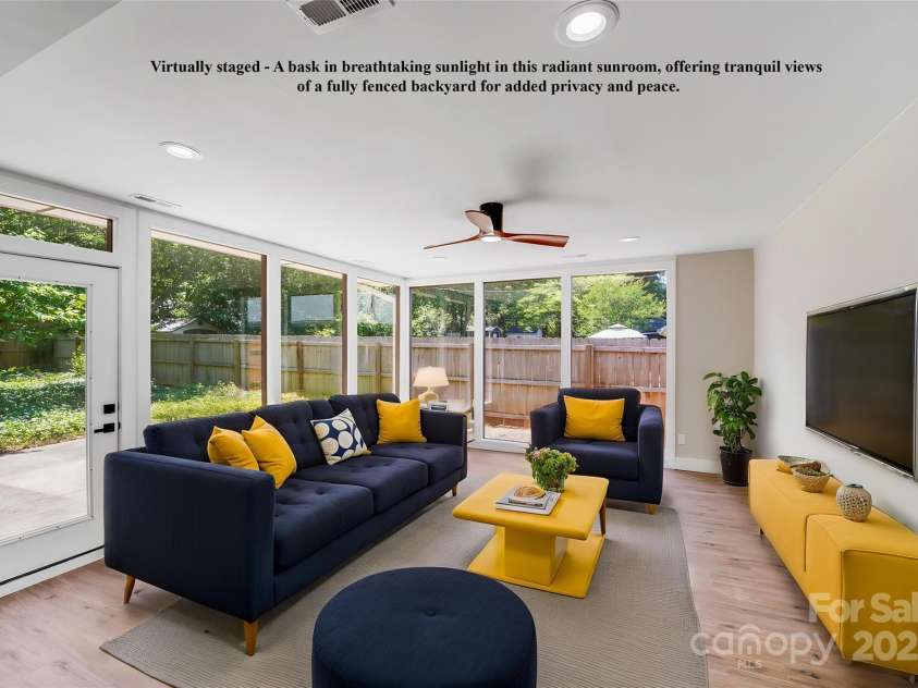 2000 Tyvola Road, Charlotte, NC 28210.  MLS# CAR4260481, YatesRealty ID 16600. Virtually staged - A bask in breathtaking sunlight in this radiant sunroom, offering tranquil views of a fully fenced backyard for added privacy and peace.