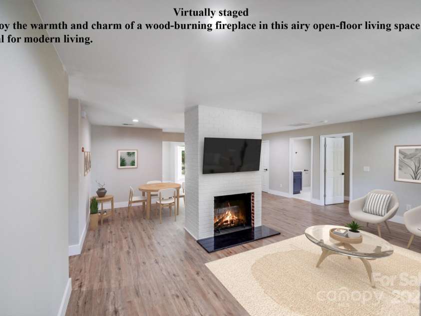 2000 Tyvola Road, Charlotte, NC 28210.  MLS# CAR4260481, YatesRealty ID 16600. Virtually Staged - Enjoy the warmth and charm of a wood-burning fireplace in this airy open-floor living space ideal for modern living.