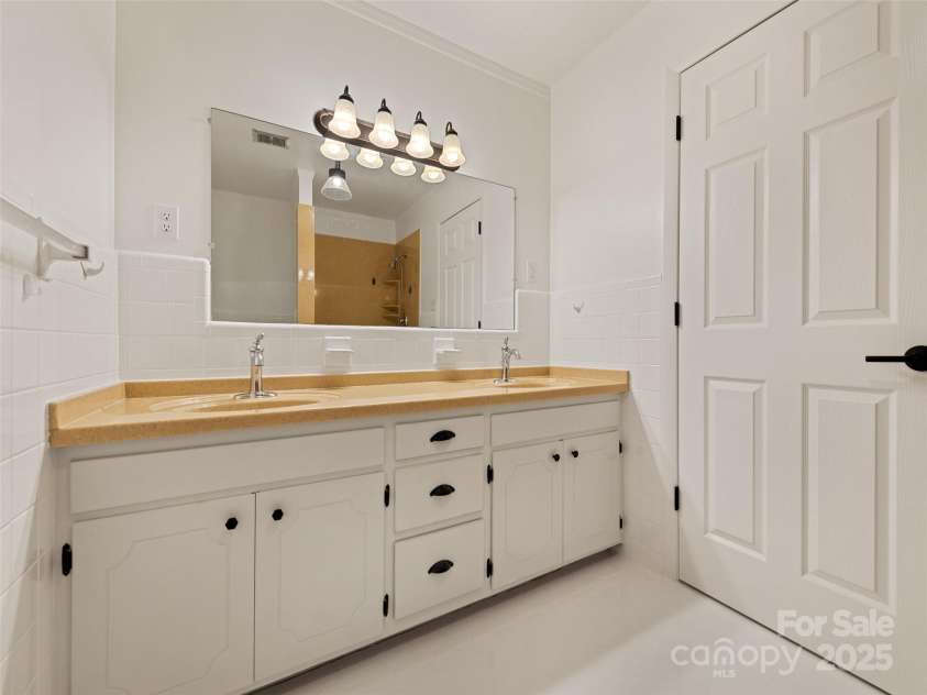 106 Whispering Hills Drive, Hendersonville, NC 28792.  MLS# CAR4251475, YatesRealty ID 16616. Bathroom with double vanity
