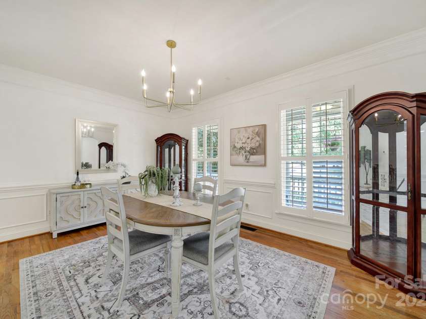 1569 Benjamen Latrobe Circle, Fort Mill, SC 29708.  MLS# CAR4235857, YatesRealty ID 16622. Dining Room - Designed Lighting, Plantation Shutters, Wood Floors, Heavy Molding