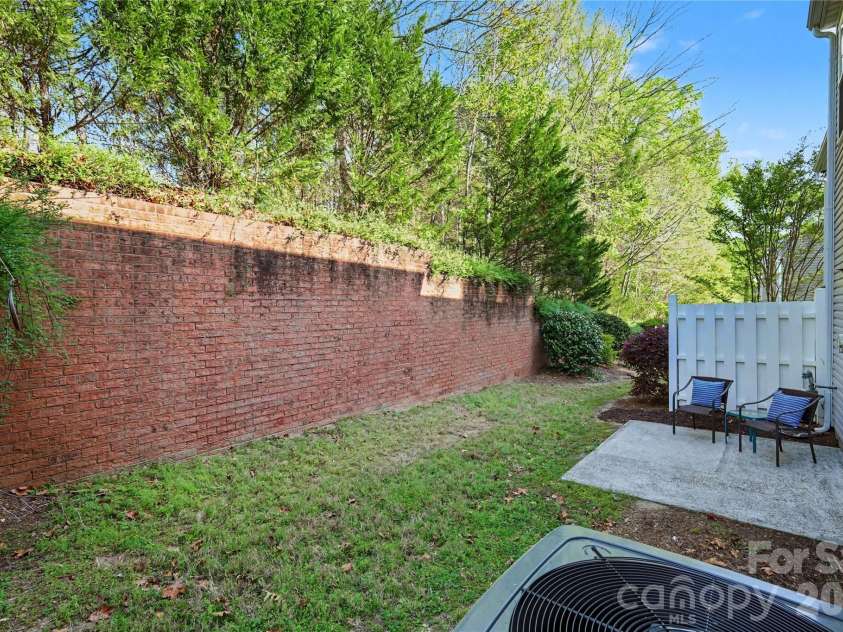 6930 Beverly Springs Drive, Charlotte, NC 28270.  MLS# CAR4363174, YatesRealty ID 16629. Charming back patio with a peaceful natural backdrop.