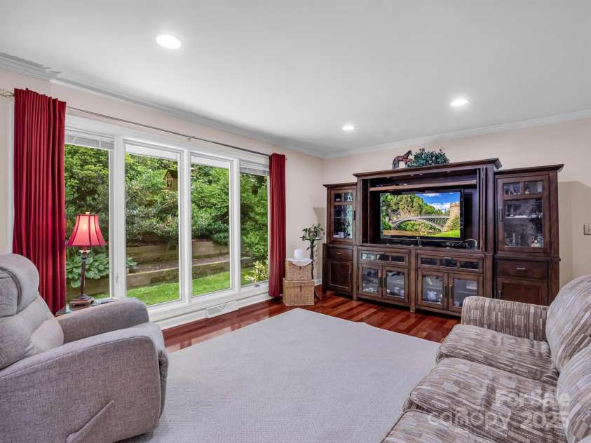 24 Middlemount Road, Pisgah Forest, NC 28768.  MLS# CAR4245556, YatesRealty ID 16634. Living room with large windo to watch the birds out back