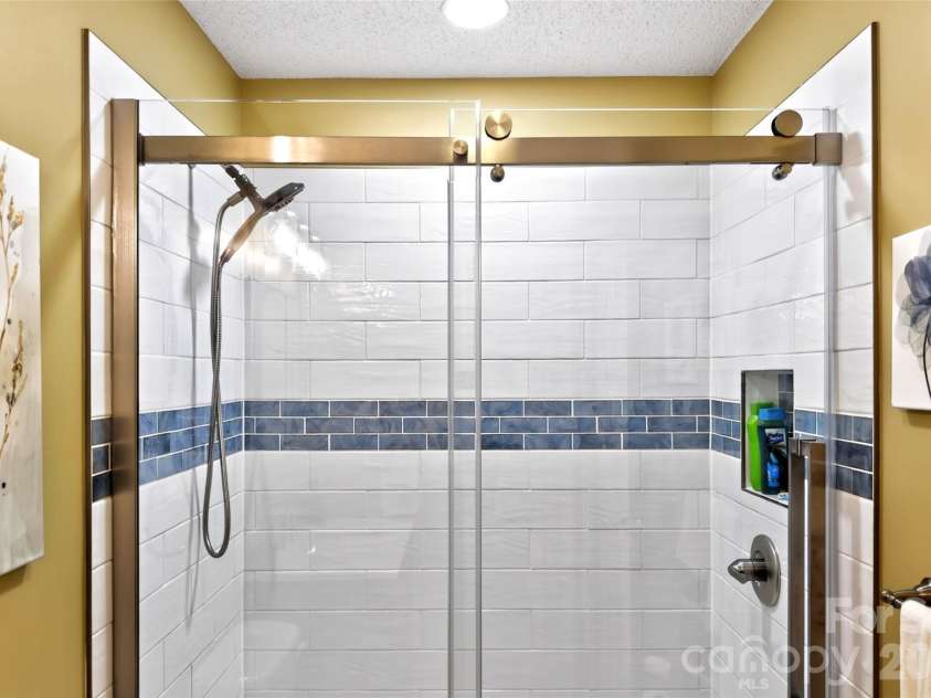 54 Deer Run Drive, Marion, NC 28752.  MLS# CAR4366901, YatesRealty ID 16636. Hallway Bath has new walk in shower with attractive tile design