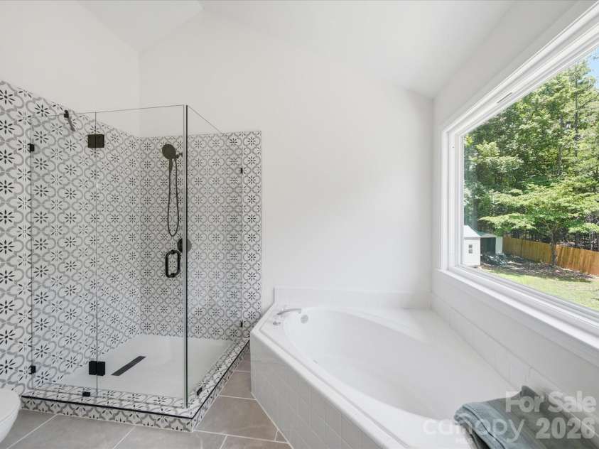 3919 Cherrybrook Drive, Mint Hill, NC 28227.  MLS# CAR4361904, YatesRealty ID 16653. Tiled shower including the floor, no plastic inserts here! Plus a beautiful glass enclosure