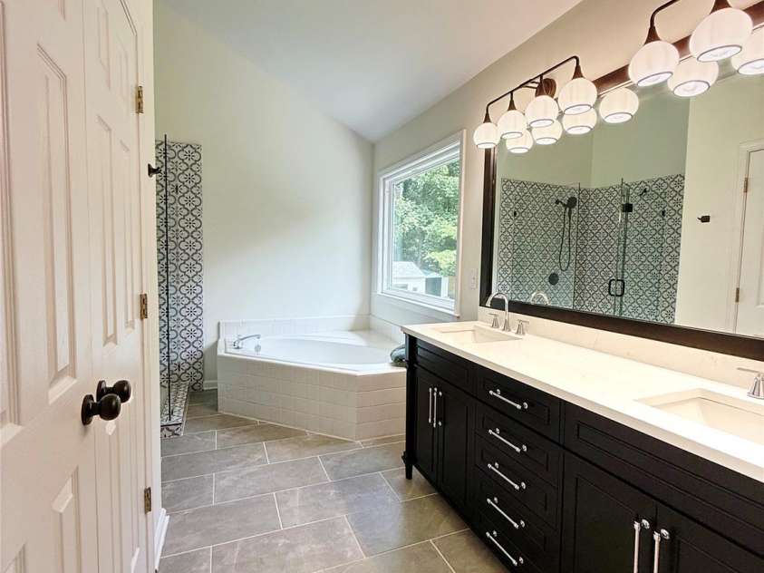 3919 Cherrybrook Drive, Mint Hill, NC 28227.  MLS# CAR4361904, YatesRealty ID 16653. Updated primary bathroom with a beautiful vanity and modern tile.