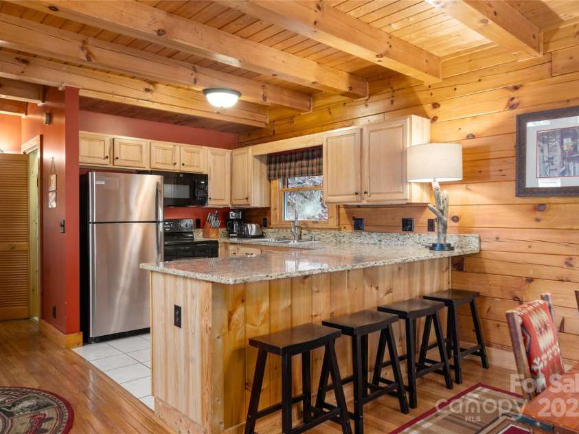 339 Tsalagi Trail, Maggie Valley, NC 28751.  MLS# CAR4263585, YatesRealty ID 16666. Wood beams and Granite tops on the Breakfast bar