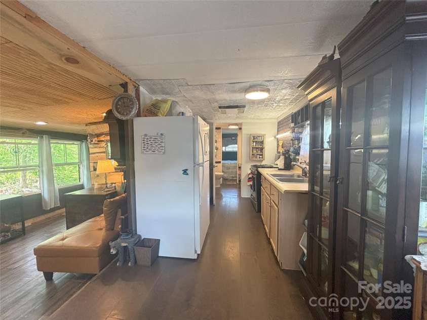 101 Mallard Loop, Waynesville, NC 28785.  MLS# CAR4257285, YatesRealty ID 16684. Kitchenette and living room.