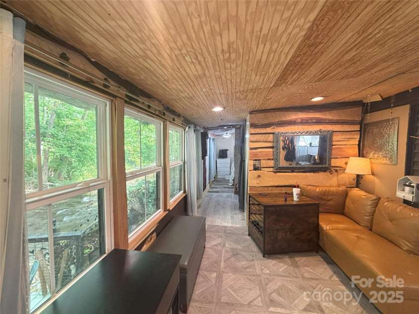 101 Mallard Loop, Waynesville, NC 28785.  MLS# CAR4257285, YatesRealty ID 16684. Living room from where you can enjoy the view of the river.