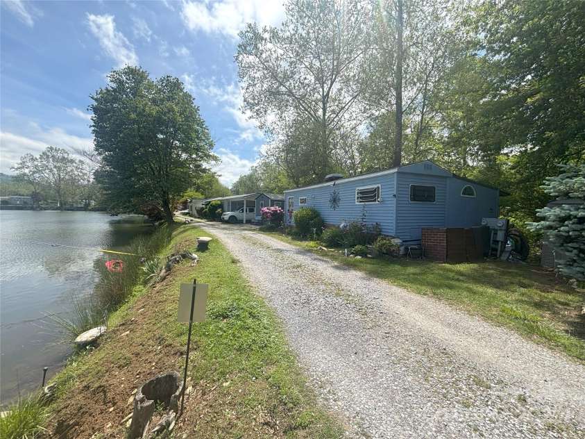 101 Mallard Loop, Waynesville, NC 28785.  MLS# CAR4257285, YatesRealty ID 16684. The house facing the lake.