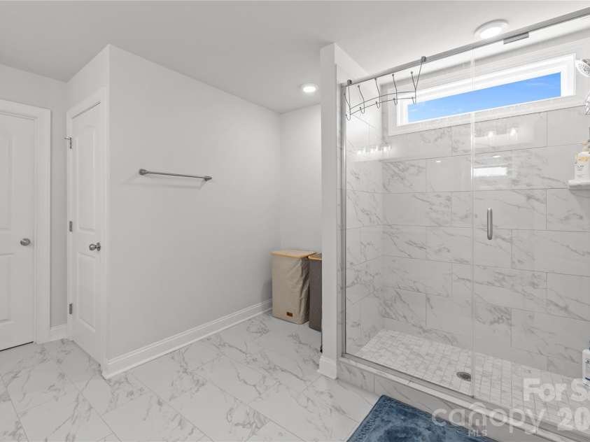 1308 Ashe Meadow Drive, Indian Trail, NC 28079.  MLS# CAR4361531, YatesRealty ID 16685. GIANT SHOWER ENCLOSURE IN PRIMARY BATH WITH SEMI-FRAMELESS GLASS & TILE