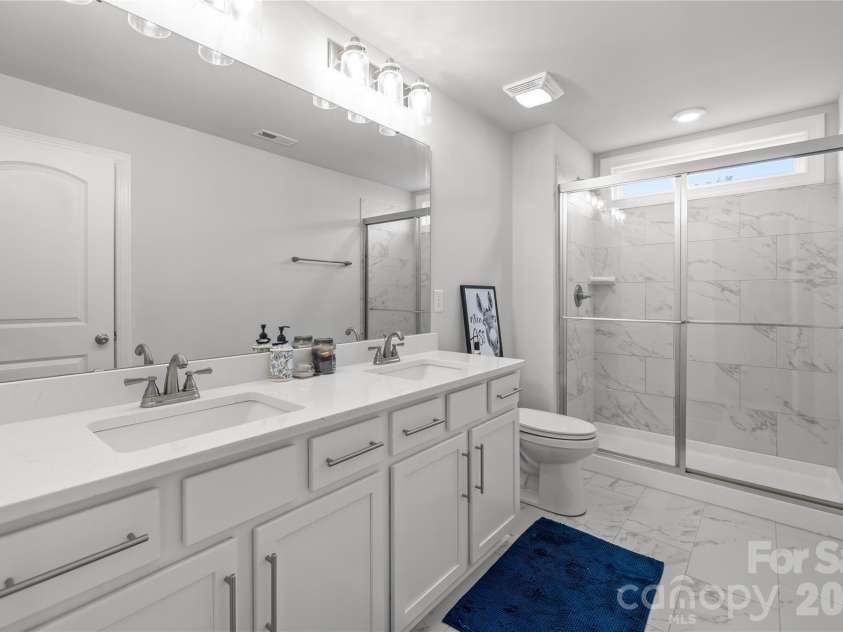 1308 Ashe Meadow Drive, Indian Trail, NC 28079.  MLS# CAR4361531, YatesRealty ID 16685. ONE OF 2 UPPER LEVEL FULL BATHS FEATURING DOUBLE SINKS AND A WALK IN SHOWER. ESSENTIALLY, EACH BEDROOM IN THE HOME HAS ITS OWN FULL BATHROOM