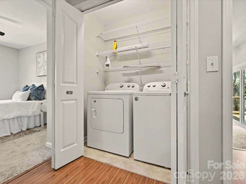 9539 Stawell Drive, Huntersville, NC 28078.  MLS# CAR4387348, YatesRealty ID 16702. The conveniently located laundry area offers practical functionality with built-in shelving for storage and easy access to the home's upper-level living spaces.