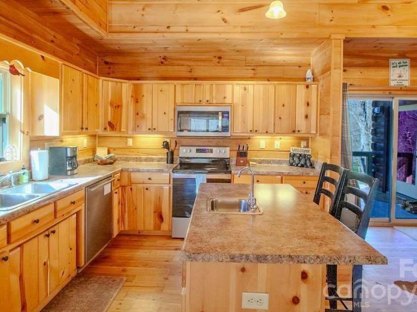 187 Gardeners Cove, Whittier, NC 28789.  MLS# CAR4355079, YatesRealty ID 16705. Open kitchen with ample storage and island. Prep sink in the island