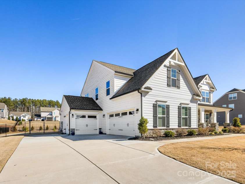 702 Yucatan Drive, Waxhaw, NC 28173.  MLS# CAR4223915, YatesRealty ID 1672. Side view of 3 car garage