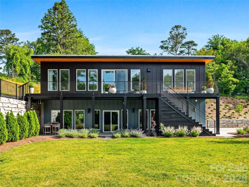 8 Midland Drive, Asheville, NC 28804.  MLS# CAR4344575, YatesRealty ID 16751. Modern architecture frames floor-to-ceiling windows capturing the property's natural light and views. Professionally landscaped yard, clean lines, and thoughtful design create a sophisticated contemporary aesthetic.
