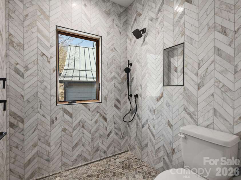 48 Verde Drive, Asheville, NC 28806.  MLS# CAR4364556, YatesRealty ID 16757. Representative photo from 50 Verde Drive showing the builder’s quality of construction and finish level, including a primary ensuite with fully tiled walk-in shower, designer fixtures, window for natural light, and detailed