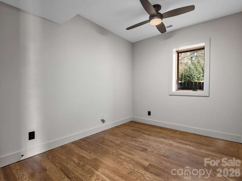 48 Verde Drive, Asheville, NC 28806.  MLS# CAR4364556, YatesRealty ID 16757. Representative photo from 50 Verde Drive showing the builder’s quality of construction and finish level, including a third bedroom or office/study with oak hardwood floors, ceiling fan, and flexible use potential.