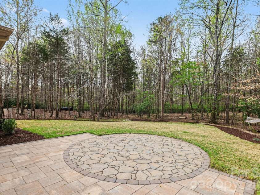 17909 Nodghia Circle, Davidson, NC 28036.  MLS# CAR4363596, YatesRealty ID 16766. Expanded patio overlooking expansive yard and woods.  Room for a pool!!  I have pool renderings.