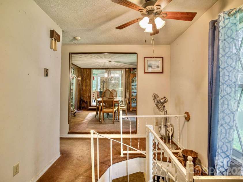 3050 Old Johns River Road, Collettsville, NC 28611.  MLS# CAR4174150, YatesRealty ID 16769. Spiral metal stairs down to the finished basement.