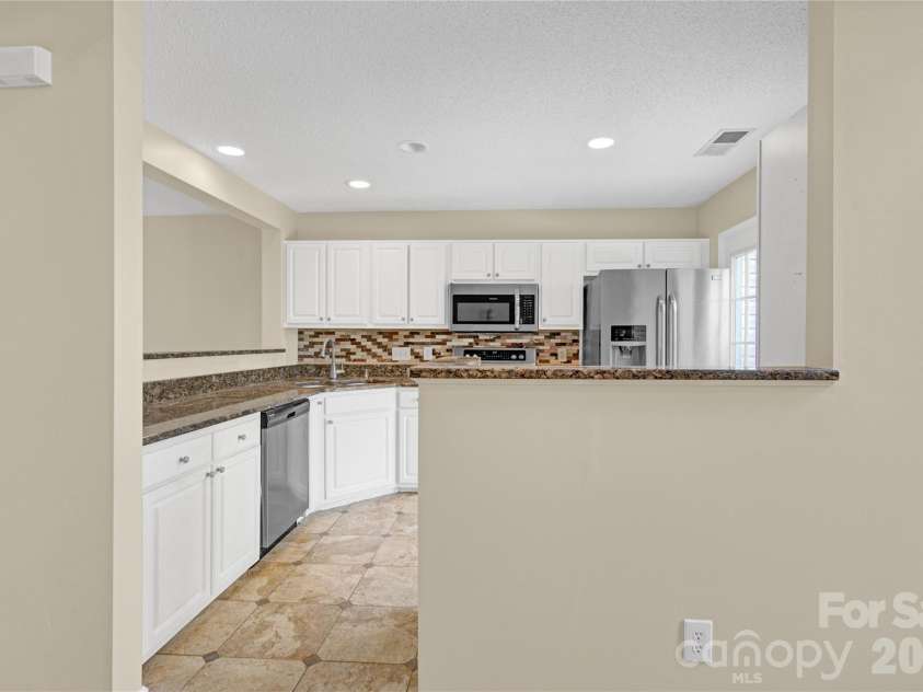 8772 Robinson Forest Drive, Charlotte, NC 28277.  MLS# CAR4389286, YatesRealty ID 16774. Kitchen from living room