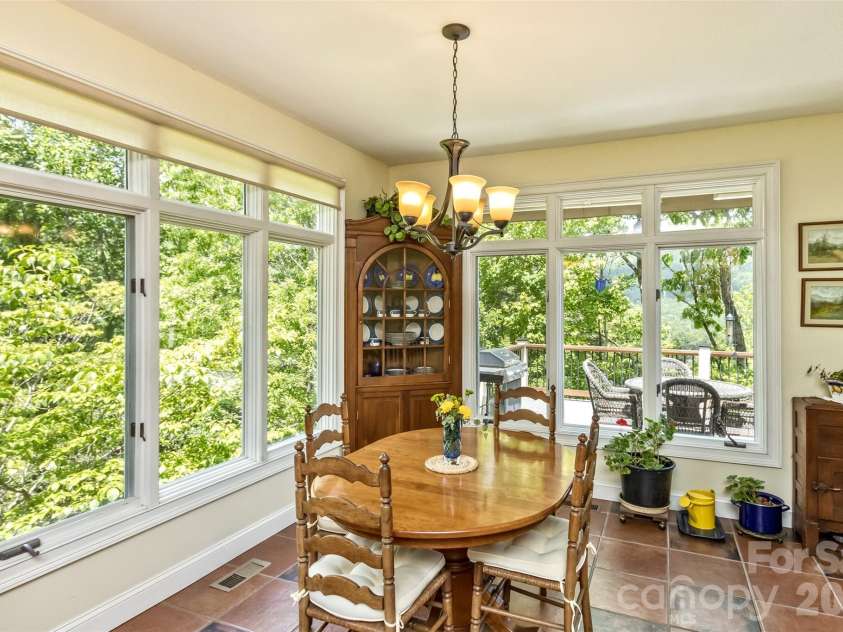 25 Windsong Drive, Fairview, NC 28730.  MLS# CAR4370725, YatesRealty ID 16777. Breakfast nook leading to deck - views from all the windows!