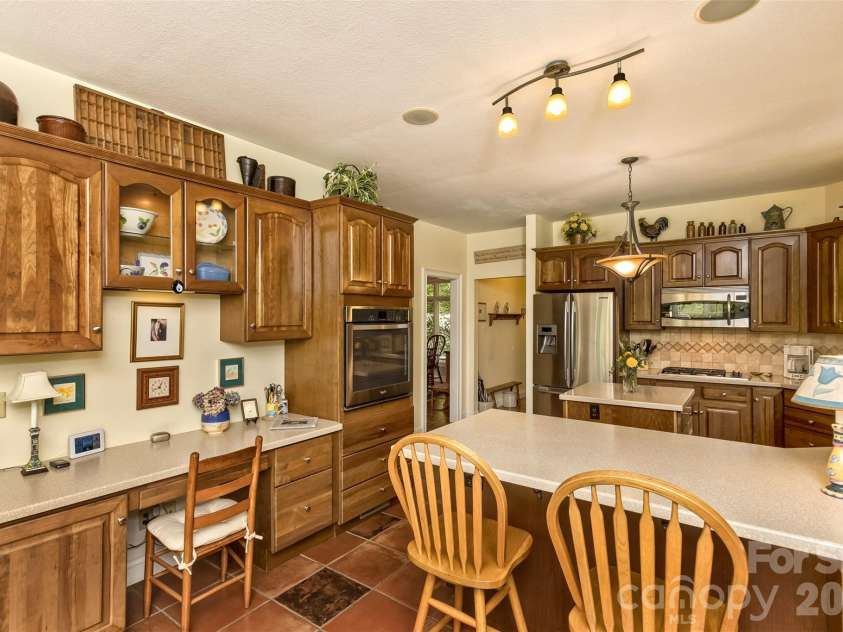 25 Windsong Drive, Fairview, NC 28730.  MLS# CAR4370725, YatesRealty ID 16777. Kitchen also includes a desk area!