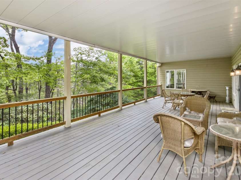 25 Windsong Drive, Fairview, NC 28730.  MLS# CAR4370725, YatesRealty ID 16777. Lower Level Deck is covered and nestled in nature
