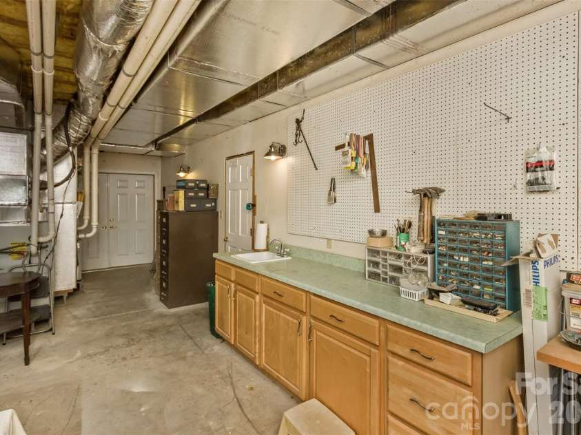 25 Windsong Drive, Fairview, NC 28730.  MLS# CAR4370725, YatesRealty ID 16777. Work Shop off Garage with Sink