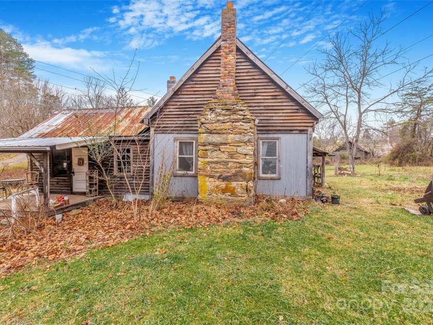 1 Mustang Drive, Leicester, NC 28748.  MLS# CAR4327824, YatesRealty ID 1681. Flat free nature land surrounds the house. 