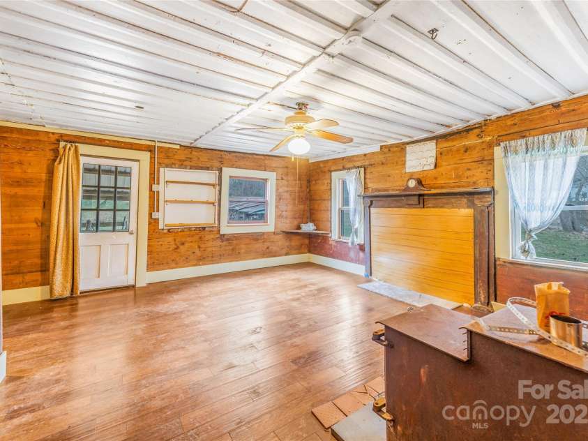 1 Mustang Drive, Leicester, NC 28748.  MLS# CAR4327824, YatesRealty ID 1681. Living room with wood stove 