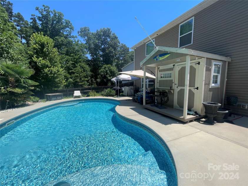 127 Tranquil Court, Locust, NC 28097.  MLS# CAR4152427, YatesRealty ID 1681. 16'x32' swimming pool with poolhouse