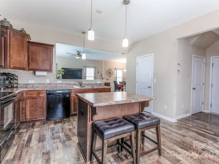 127 Tranquil Court, Locust, NC 28097.  MLS# CAR4152427, YatesRealty ID 1681. Kitchen with pantry and hallway to garage and guest/half bath